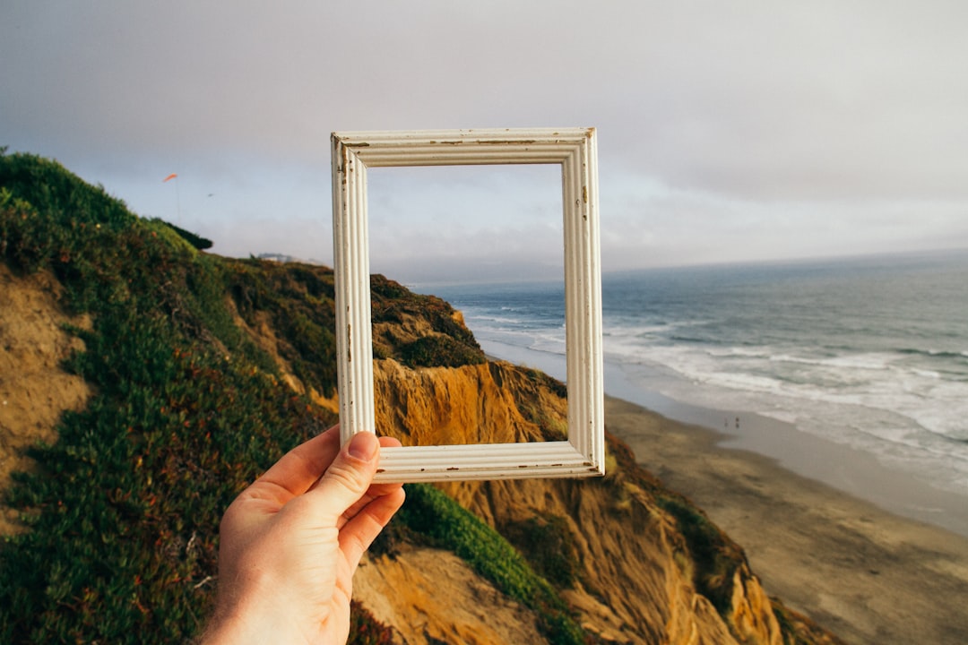 Photo by pine watt person hand holding photo frame