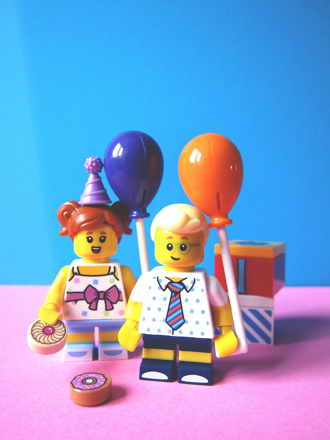 Photo by Nik girl and boy holding balloon Lego minifugures
